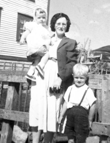 431: Anne (Ryan) Cheeseman, in front of her home on Red Island, with her grandchildren Terry and  Doris Cheeseman. (1958) [courtesy of Mary (Bennett) McLellan]  - Anne daughter of Jeremiah Ryan &amp;amp; Mary Joseph Whelan, married Joseph Cheeseman; Terry and  Doris children of Thomas Cheeseman &amp;amp; Elizabeth Corrigan